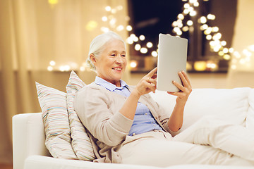 Image showing senior woman with tablet computer on christmas