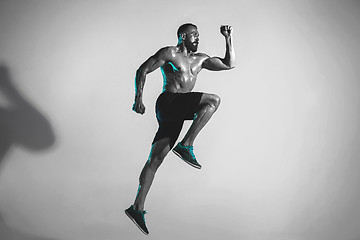 Image showing Young caucasian bodybuilder training over studio background