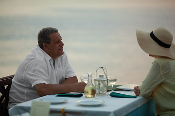 Image showing Romantic evening for mature couple in the seafront restaurant