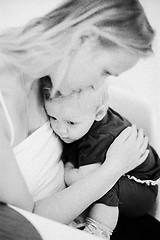 Image showing In the hugs of dear mother. Black and white family portrait