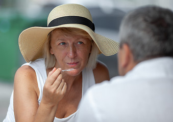 Image showing Mature woman in outside cafe