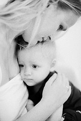 Image showing Mum embracing little daughter. Black and white shot