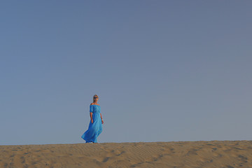 Image showing Woman in blue dress against the sky