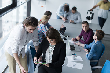 Image showing Two Business People Working With Tablet in office