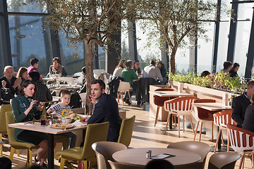 Image showing Young parents enjoying lunch time with their children