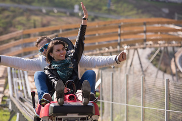 Image showing couple enjoys driving on alpine coaster