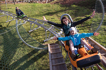 Image showing mother and son enjoys driving on alpine coaster