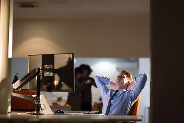 Image showing businessman relaxing at the desk