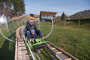 Image showing father and son enjoys driving on alpine coaster