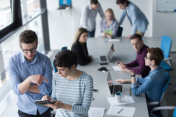 Image showing Two Business People Working With Tablet in office