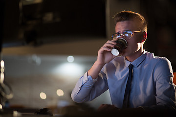 Image showing Tired businessman working late