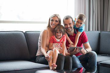 Image showing happy young couple spending time with kids