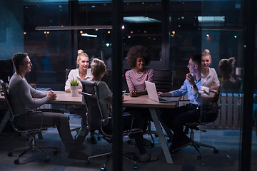 Image showing Multiethnic startup business team in night office