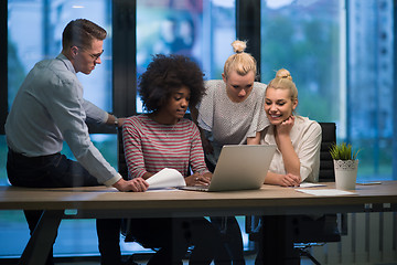 Image showing Multiethnic startup business team in night office