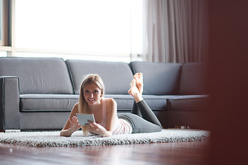 Image showing young women using tablet computer on the floor