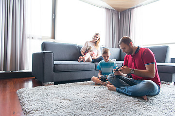 Image showing Happy family playing a video game