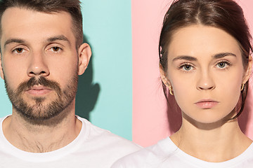 Image showing The serious man and woman looking at camera against pink and blue background.