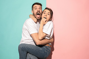 Image showing Portrait of the scared man and woman on pink and blue