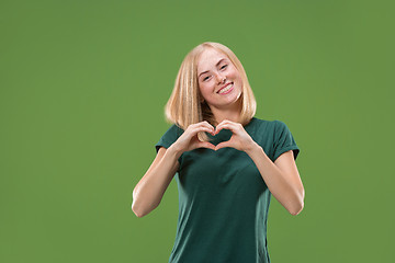 Image showing Portrait of attractive cute girl with kiss isolated over green background