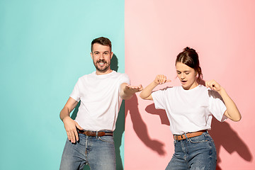 Image showing A couple of young man and woman dancing hip-hop at studio.