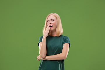 Image showing Beautiful bored woman bored isolated on green background