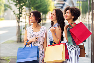 Image showing happy women with shopping bags in city