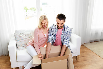 Image showing happy couple with open parcel box at home