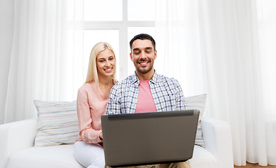 Image showing smiling happy couple with laptop at home