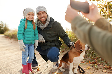 Image showing family with dog photographing by smartphone