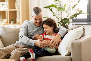 Image showing happy father with preteen and baby son at home