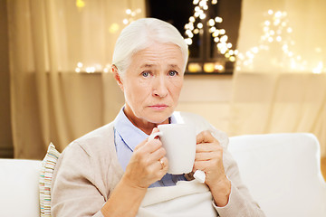 Image showing unhealthy senior woman drinking tea on christmas