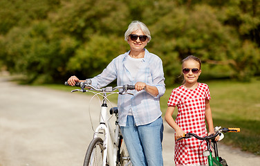 Image showing grandmother and granddaughter with bicycles