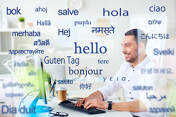 Image showing man with computer over words in foreign languages