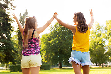 Image showing teenage girls showing peace hand sign at park