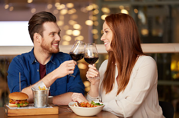 Image showing couple eating and drinking red wine at restaurant