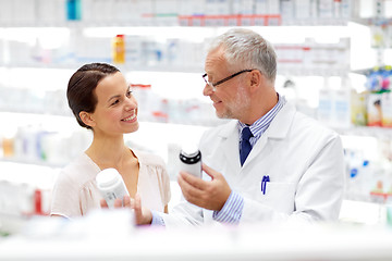 Image showing apothecary and woman with drug at pharmacy