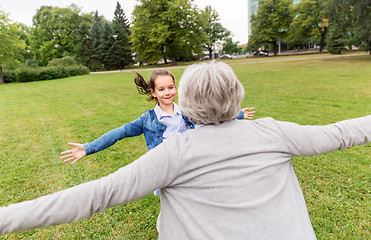 Image showing grandmother and granddaughter playing at park