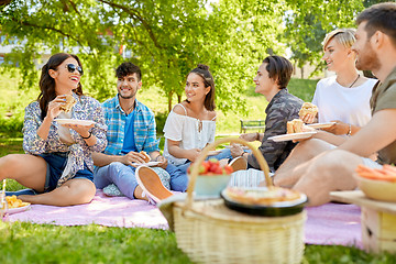 Image showing happy friends eating sandwiches at summer picnic