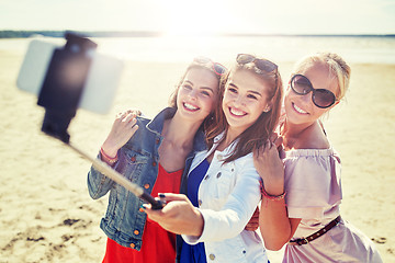 Image showing group of smiling women taking selfie on beach