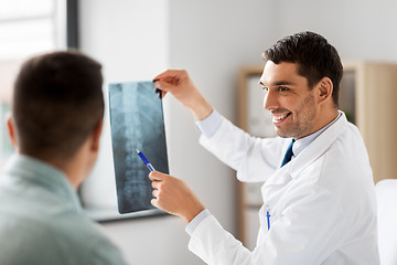 Image showing doctor showing x-ray to patient at hospital