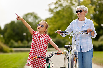 Image showing grandmother and granddaughter with bicycles