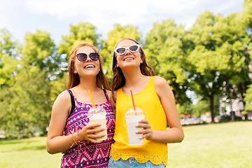 Image showing teenage girls with milk shakes at summer park