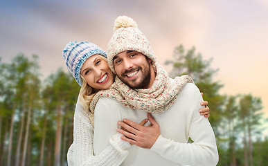 Image showing couple hugging over winter forest background