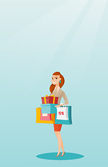 Image showing Woman holding shopping bags and gift boxes.