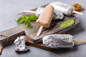 Image showing Homemade popsicle on a stick wrapped in foil.