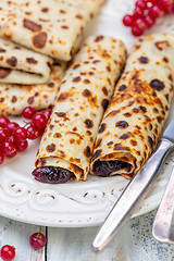 Image showing Norwegian pancakes stuffed with berry jam.