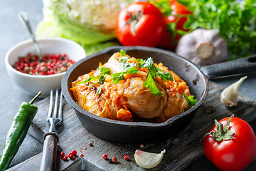 Image showing Cabbage rolls with minced meat and tomato sauce.