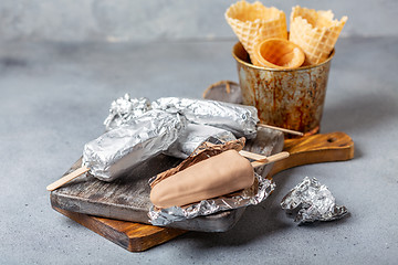 Image showing Homemade ice cream with chocolate icing on a stick.