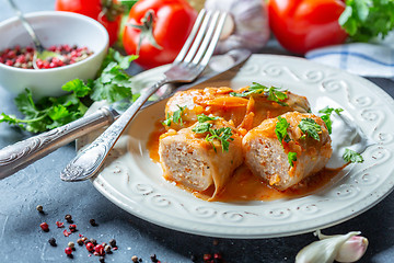 Image showing Cabbage rolls with minced meat and sour cream.