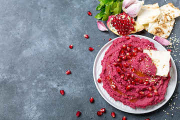 Image showing Beet hummus dip with pita bread.